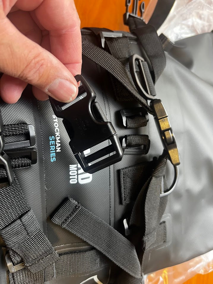 Close-up of NOMAD MOTO buckle on bag