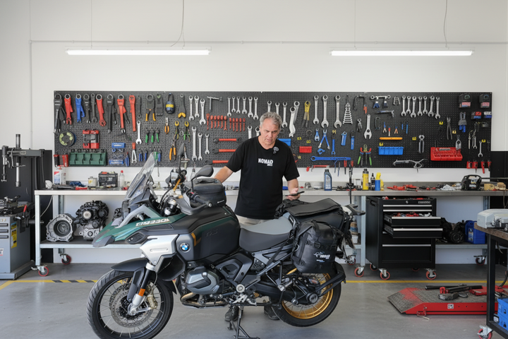 Kurt Founder Nomad Moto 1300 GS with Strzeelcki Adjustable Rackless fitted standing next to a motorcycle in a garage with vehicles and equipment in the background