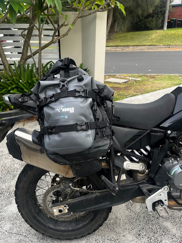 Motorcycle with a gray backpack on a street
