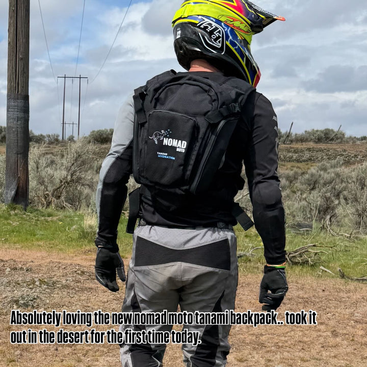 Travis Kruger a Nomad Moto customer in motocross gear with a Nomad backpack in a desert setting